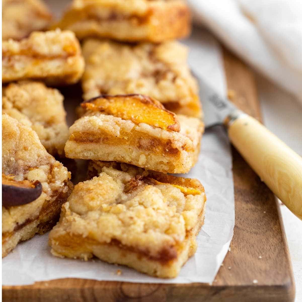 Peach Crumb Bars cut on parchment paper