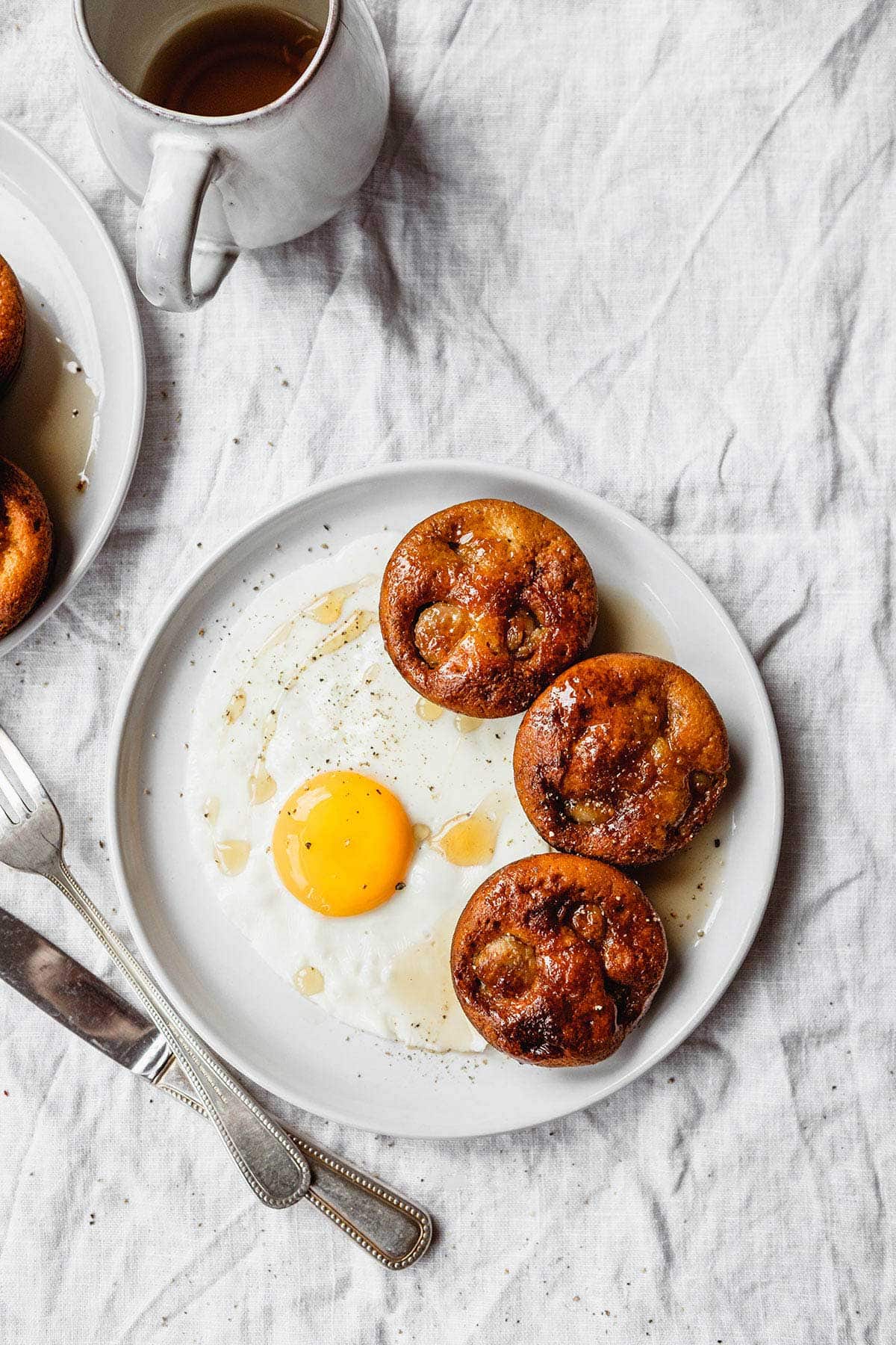 Pigs in a Pool on plate next to sunny side up egg