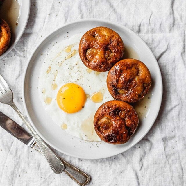 Pigs in a Pool on plate next to sunny side up egg