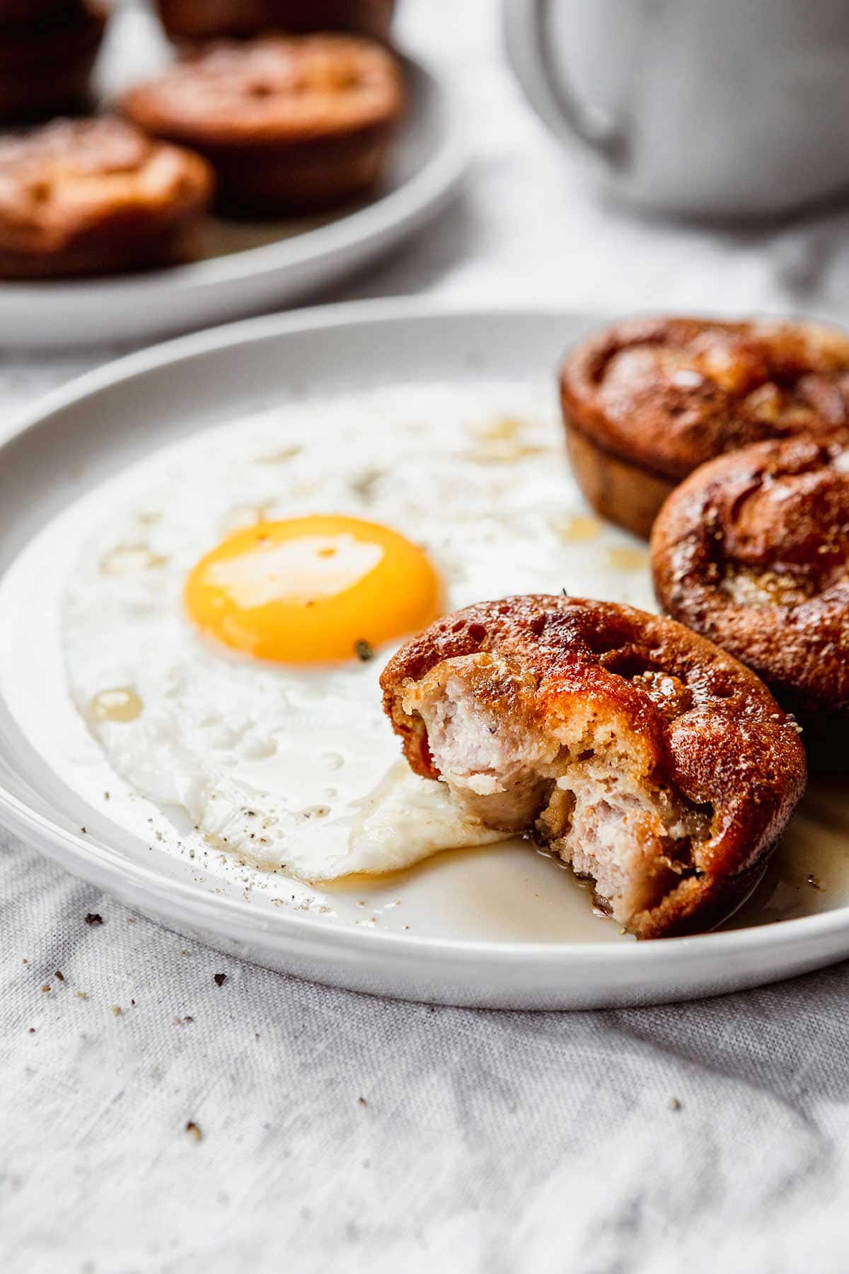 Pigs in a Pool on plate next to sunny side up egg