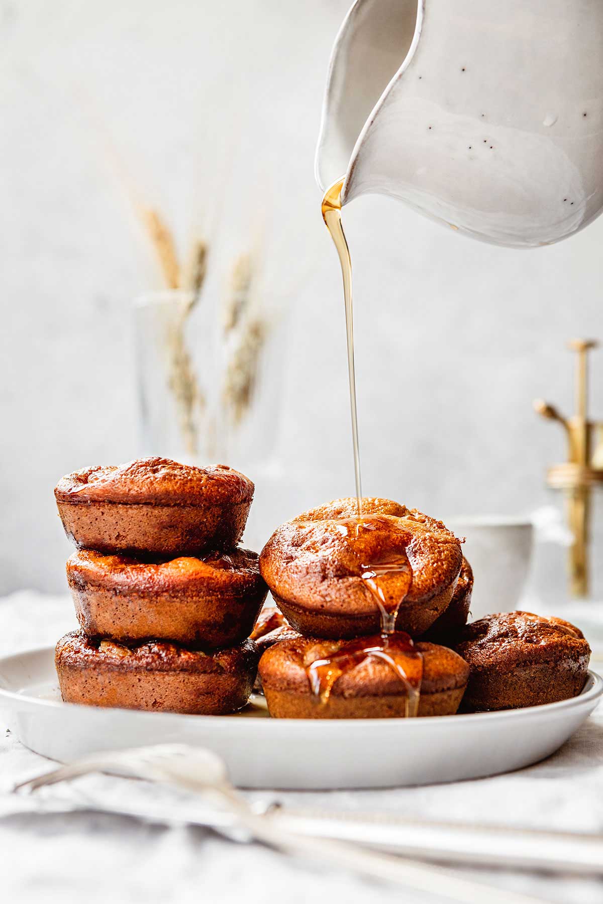 Pigs in a Pool on serving dish with maple syrup drizzled over top