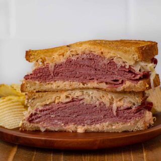 Reuben Sandwich on plate with chips