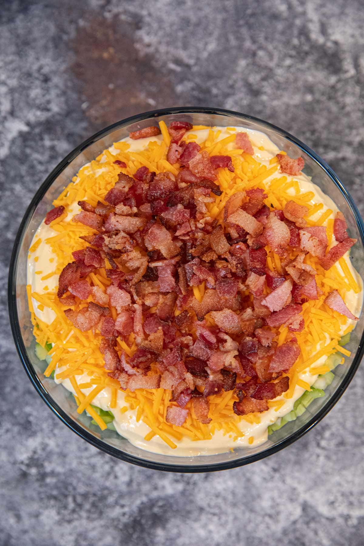 top-down view of Seven Layer Salad in glass bowl