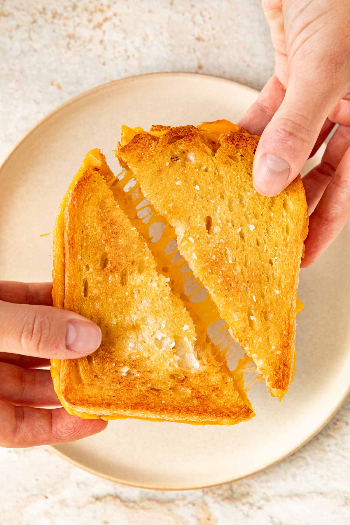 Sheet Pan Grilled Cheese sliced diagonally being pulled apart