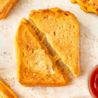 Sheet Pan Grilled Cheese Sandwiches are the easiest way to make ultimate cheesy, crispy cheese sandwiches for a crowd in less than 30 minutes! Sheet Pan Grilled Cheese sliced diagonally