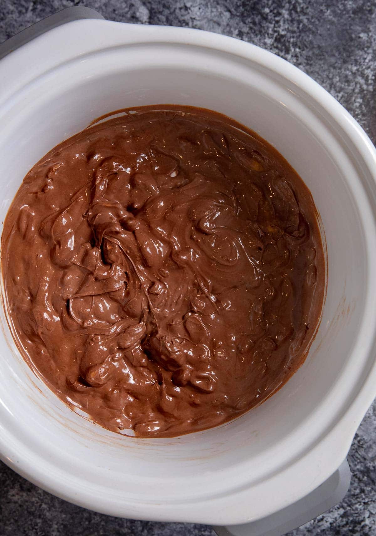 Slow Cooker Chocolate Candy melted chocolate and peanuts in crockpot