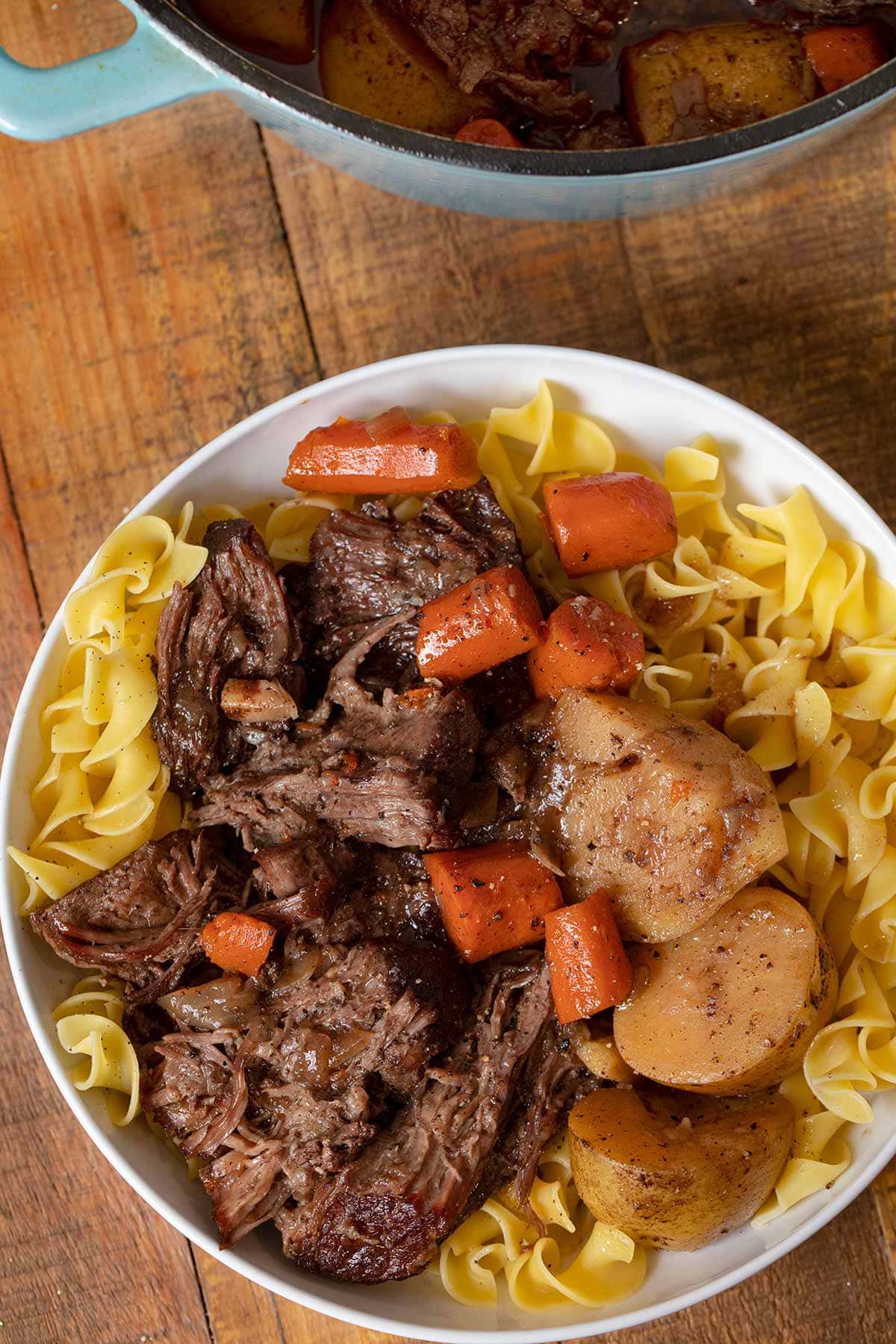 Swedish Pot Roast serving on plate with egg noodles