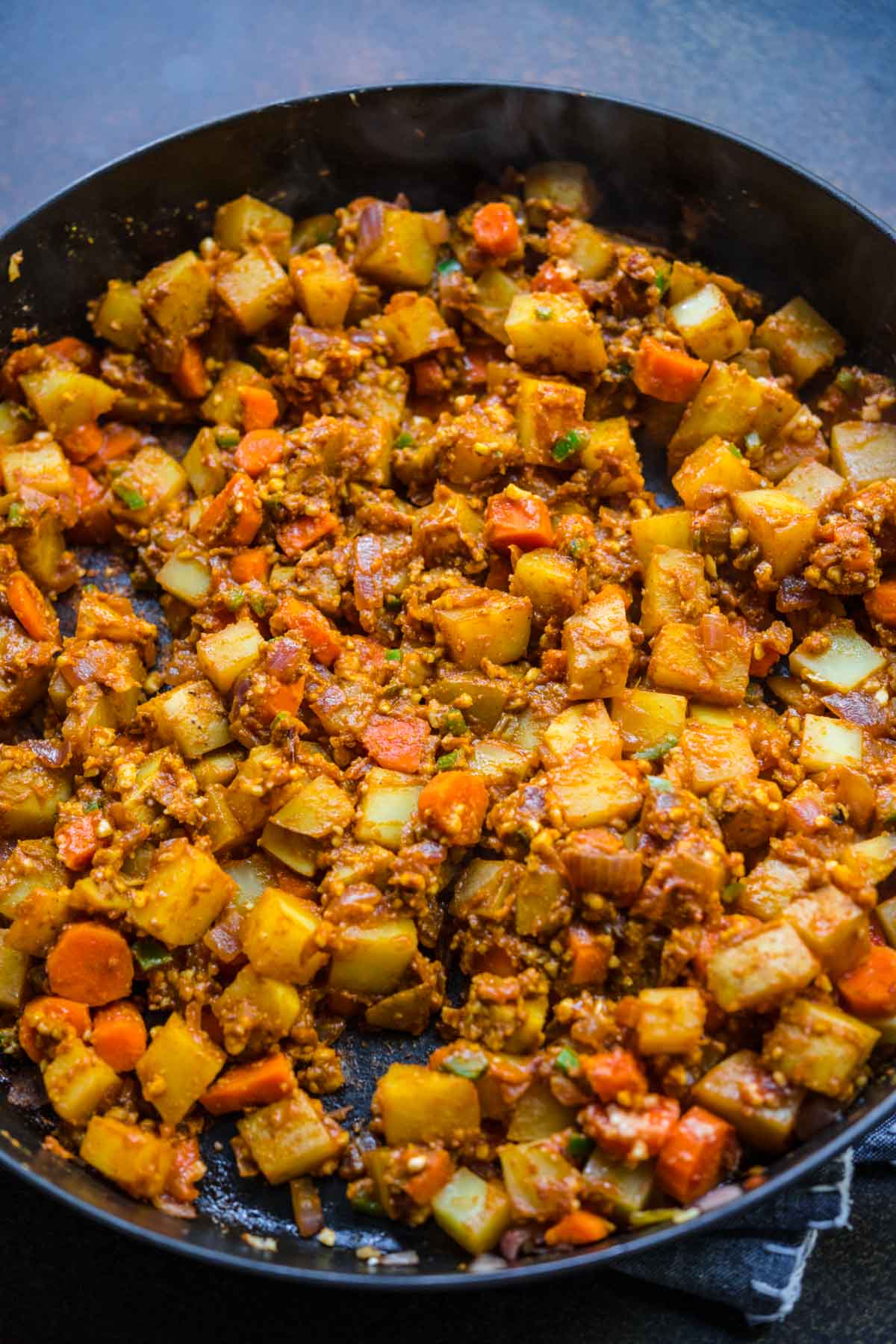 Vegetable Korma veggies and seasonings in skillet