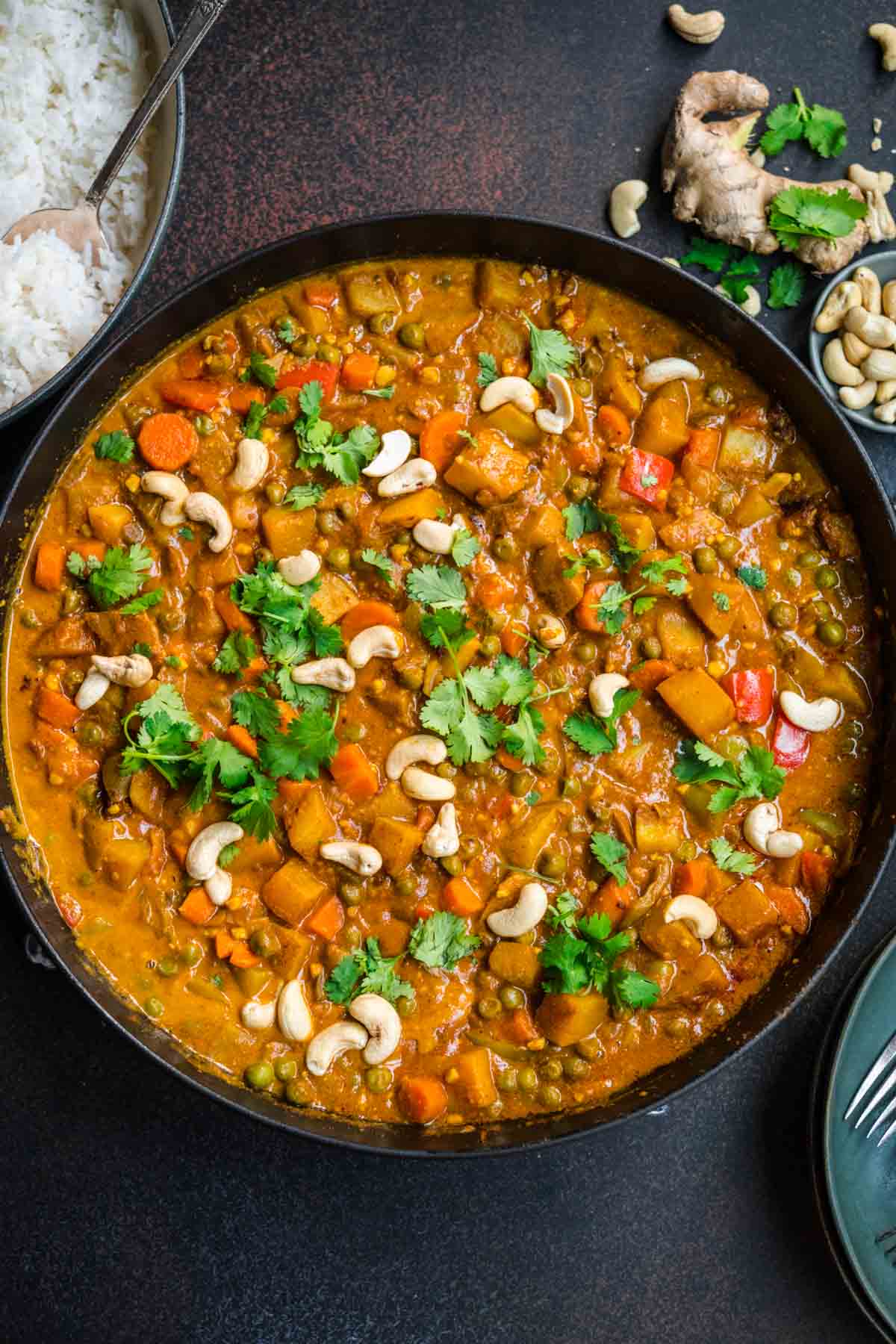 Vegetable Korma in serving bowl with cashews and cilantro garnish