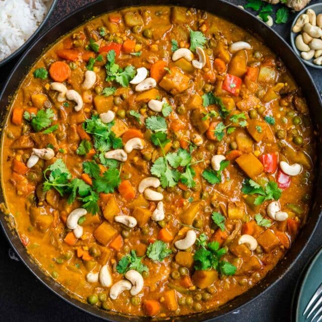 Korma in serving bowl with cashews and cilantro garnish 1x1