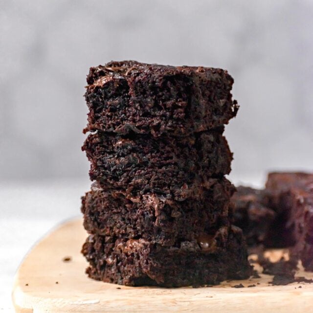 Sliced Zucchini Brownies in stackstacked on cutting board