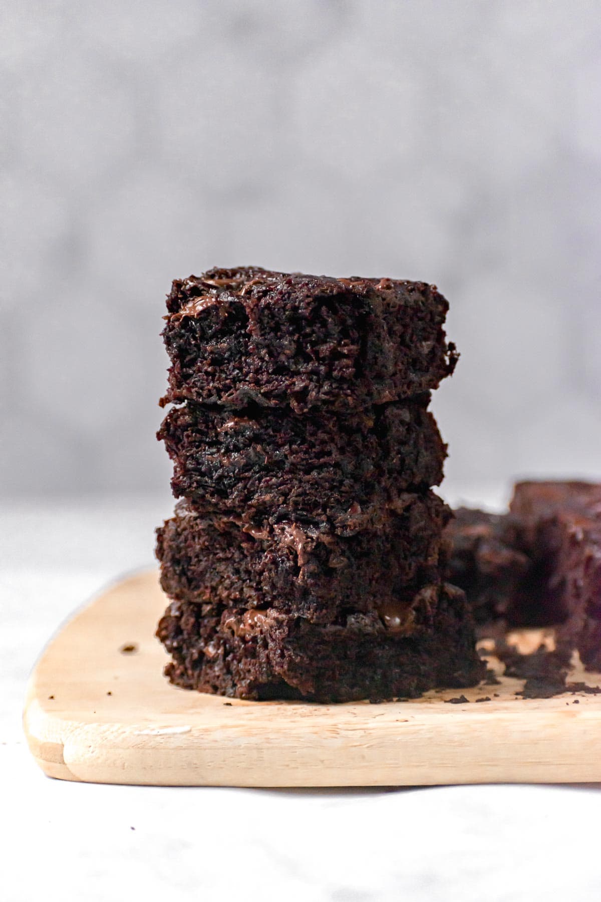 Sliced Zucchini Brownies stacked on cutting board