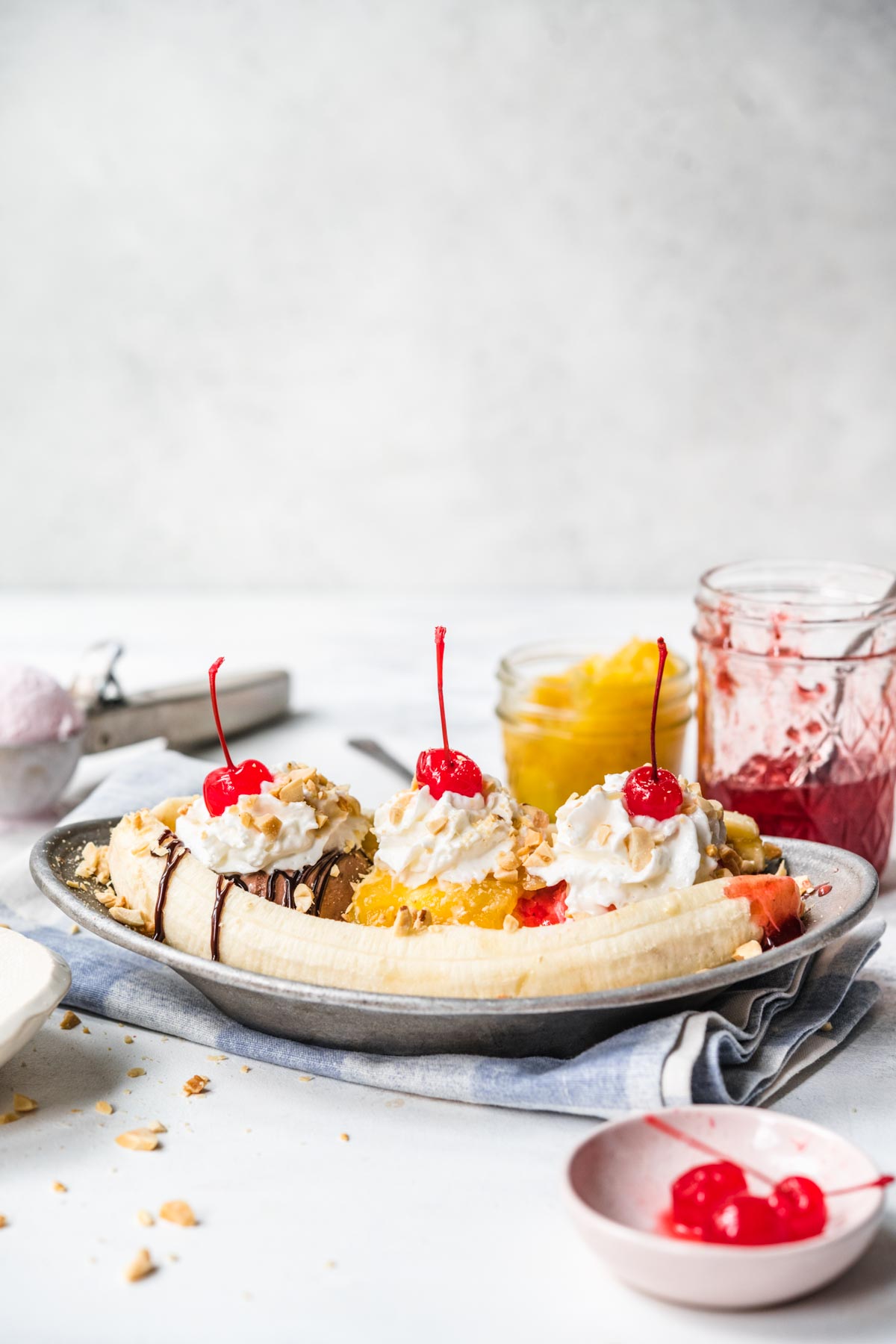 Banana Split on plate with chocolate, pineapple, and strawberry topping