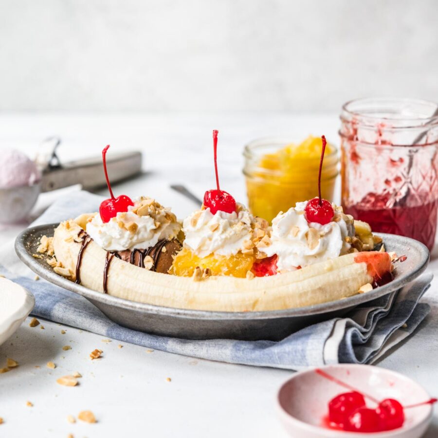 Banana Split on plate with chocolate, pineapple, and strawberry topping