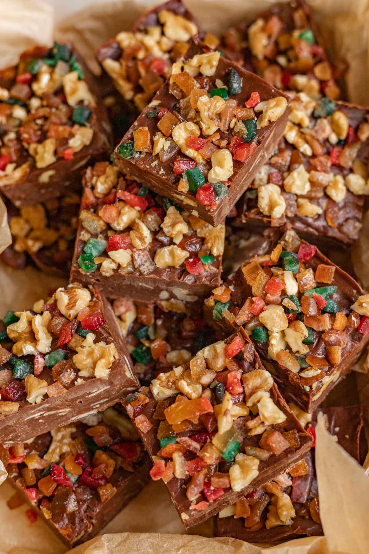 Christmas Fudge squares with nuts and candy on parchment