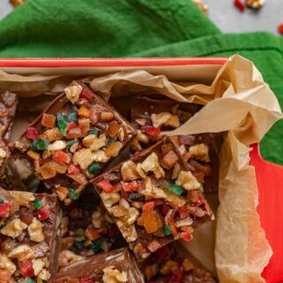 Aerial view of Fudge squares with nuts and candy on parchment in box