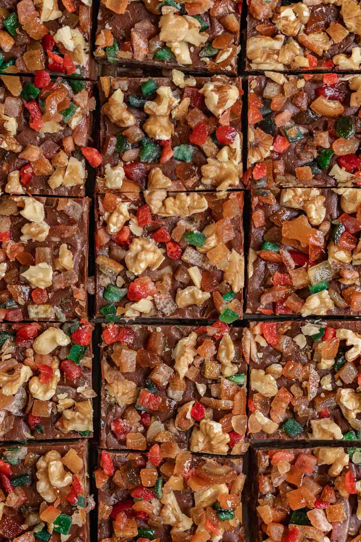 Christmas Fudge squares with nuts and candy on parchment