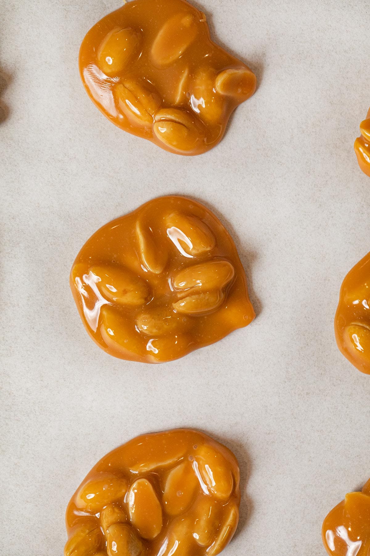 Caramel Peanut Clusters peanuts in caramel on parchment paper