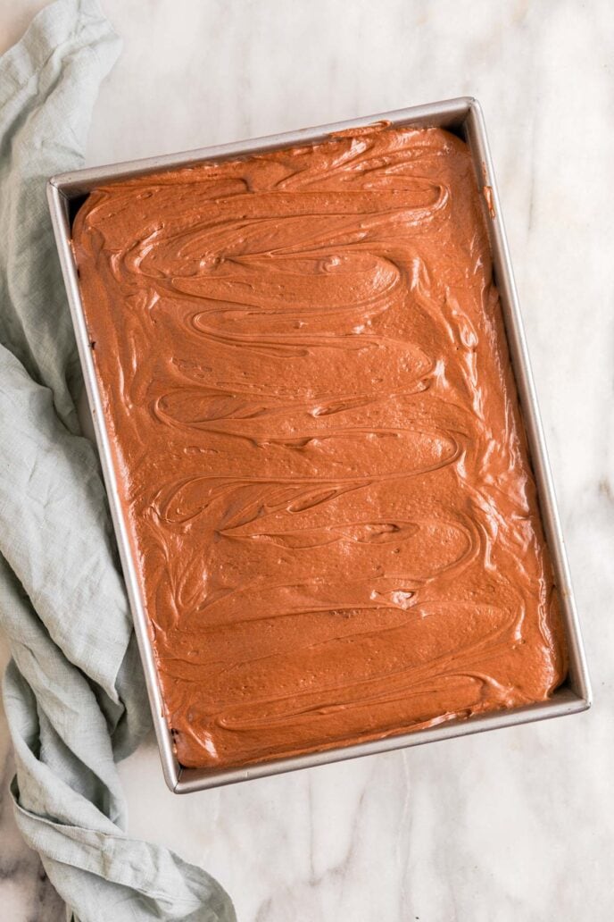 Chocolate Poke Cake Frosted in Baking Pan