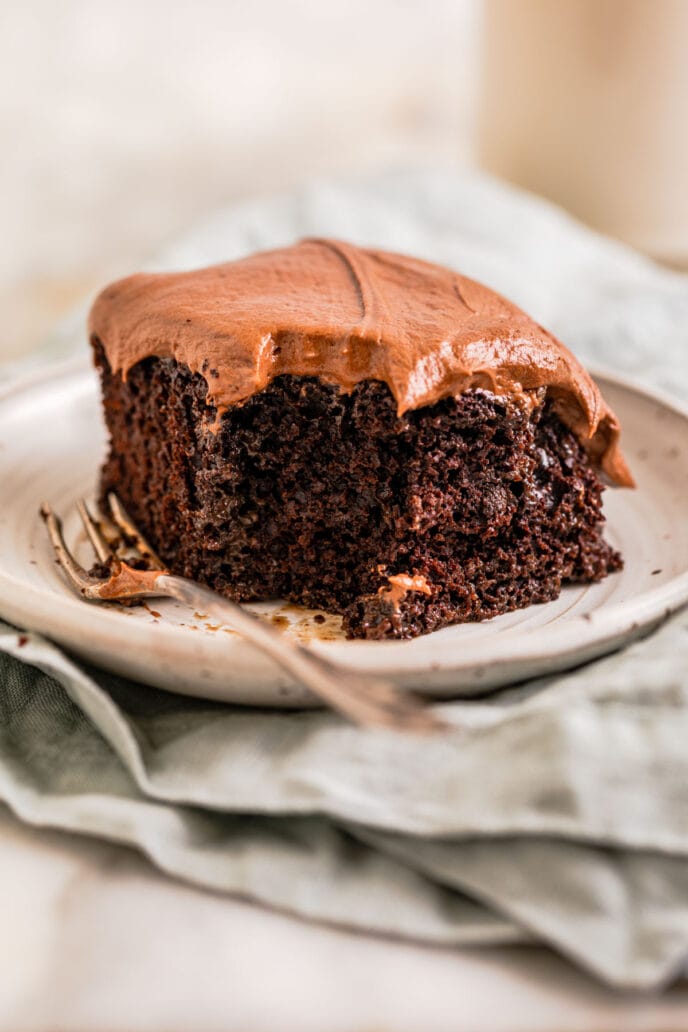 Chocolate Poke Cake Slice with Bite Removed with Fork on Plate