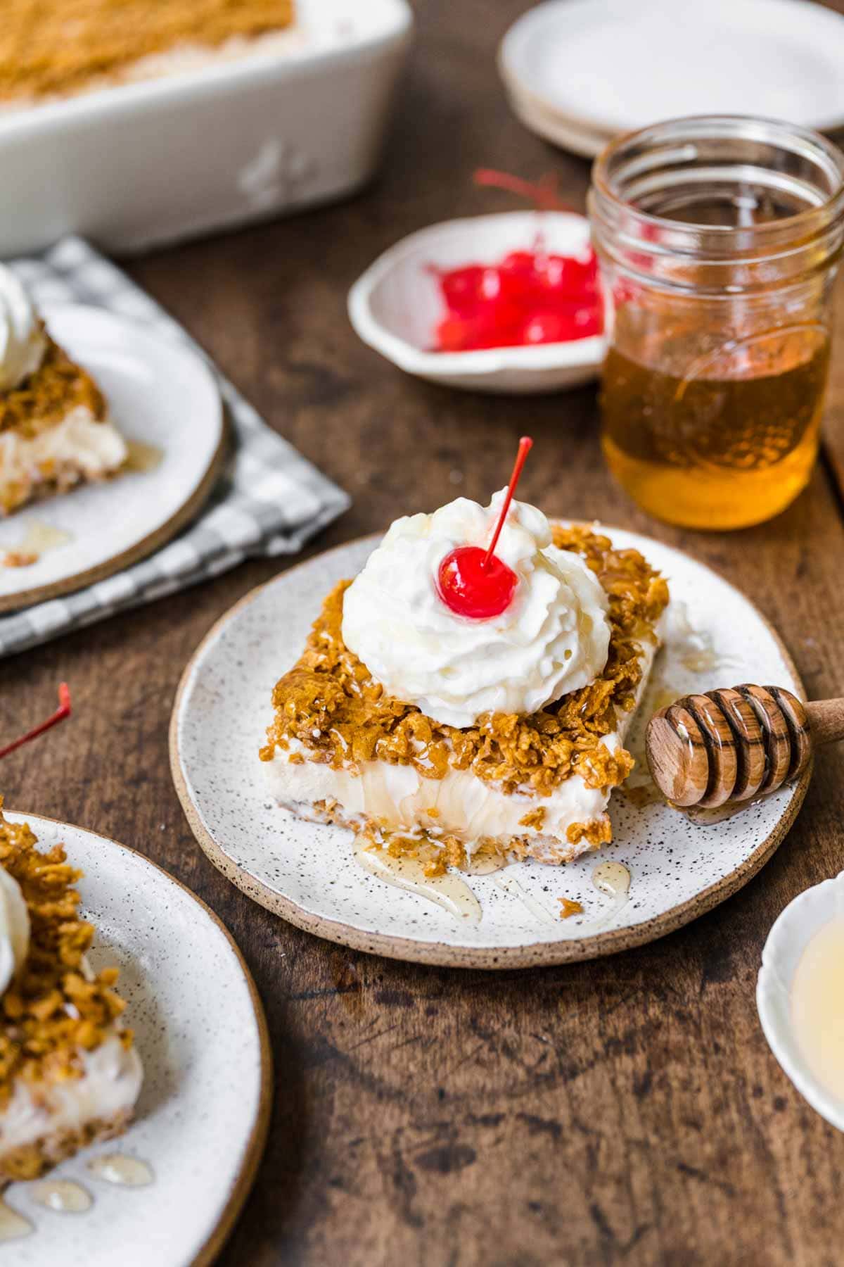 Fried Ice Cream Dessert Casserole slice on plate with whipped cream and cherry on top