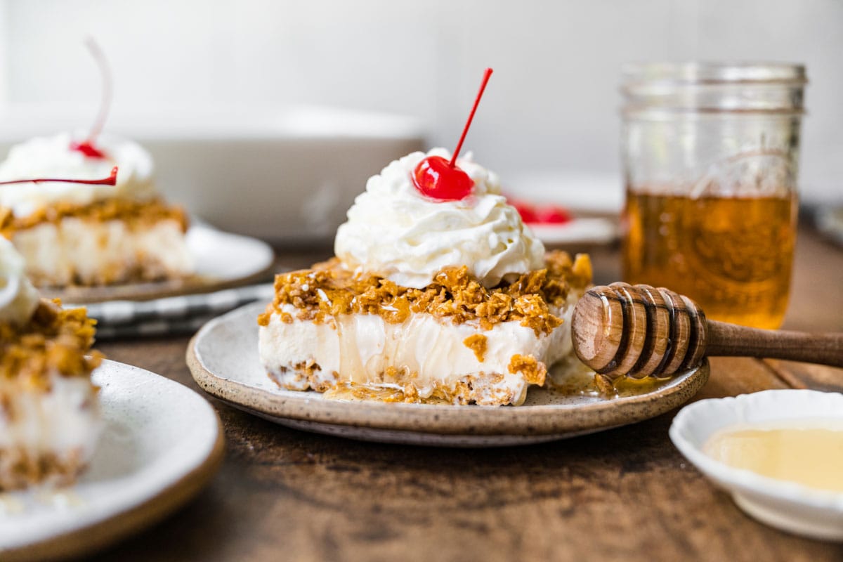 Fried Ice Cream Dessert Casserole slice on plate with whipped cream and cherry on top