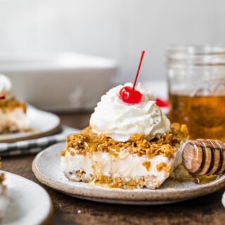 Fried Ice Cream Dessert Casserole slice on plate with whipped cream and cherry on top