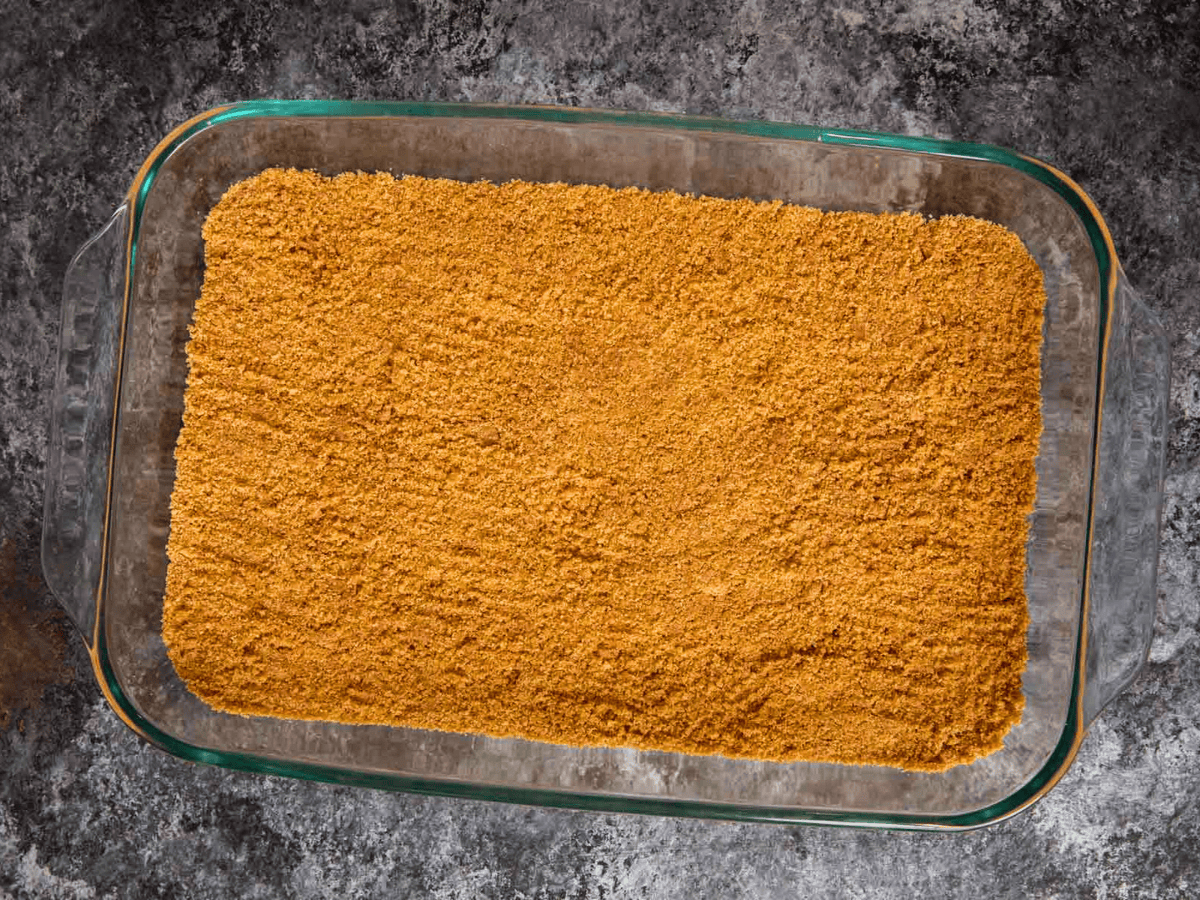 graham cracker dust in a glass pan