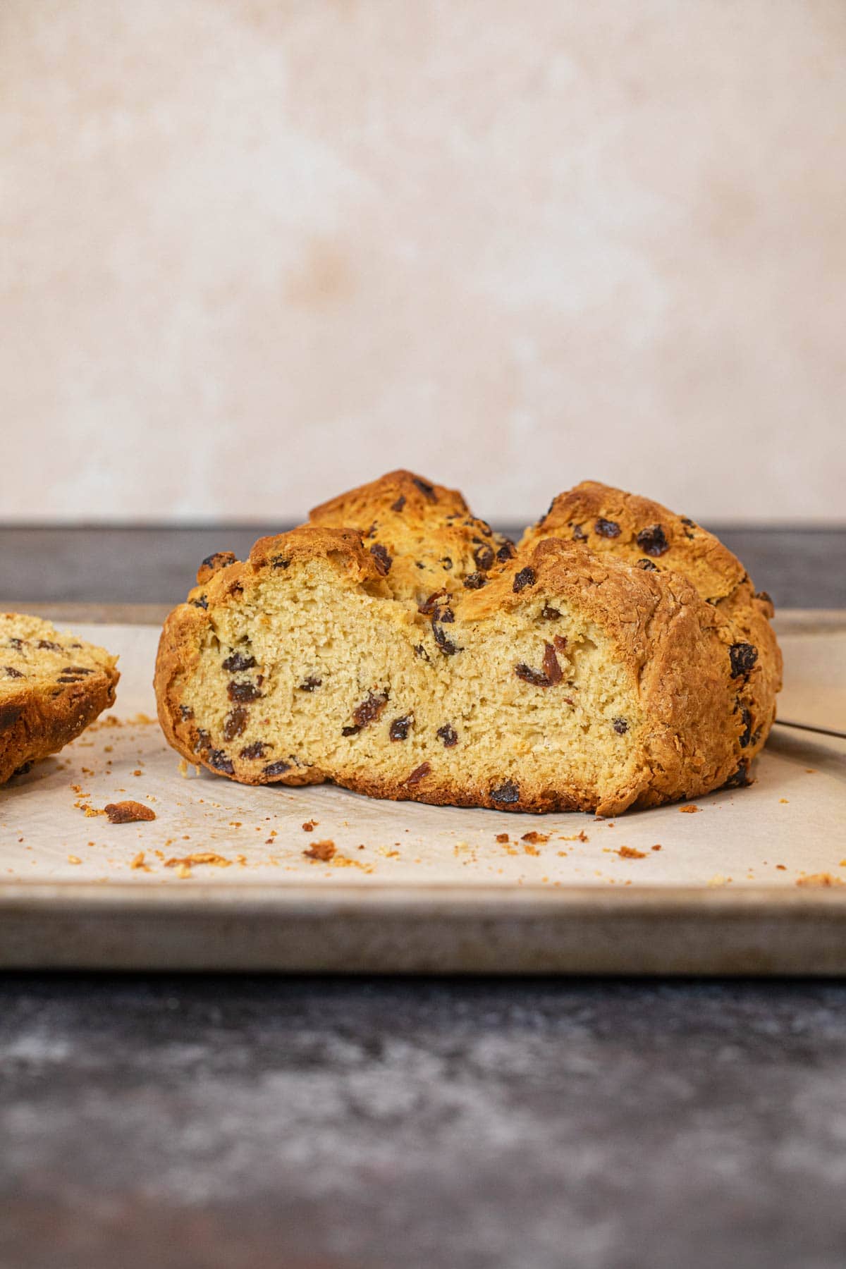 Irish Soda Bread loaf sliced in half on baking sheet