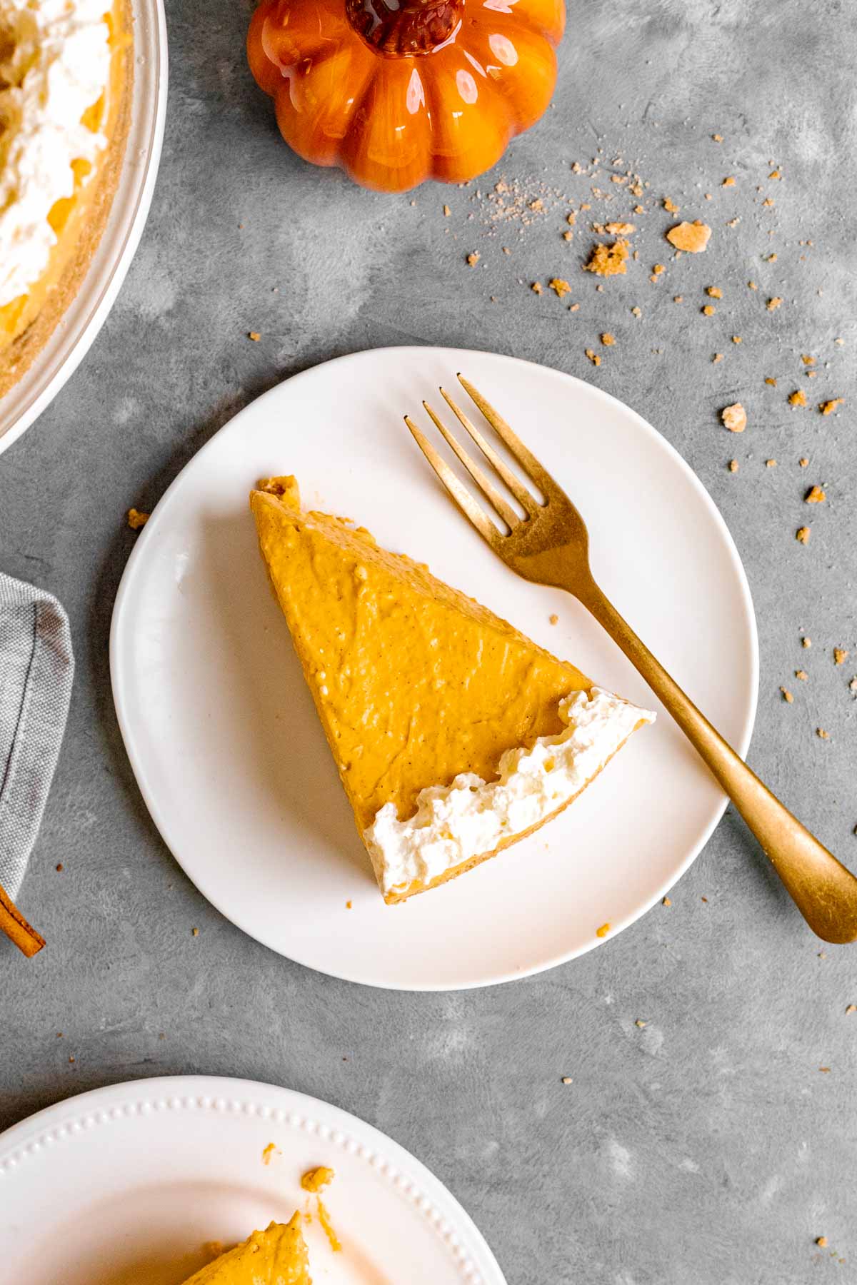 Slice of no-bake pumpkin cheesecake served on a plate.