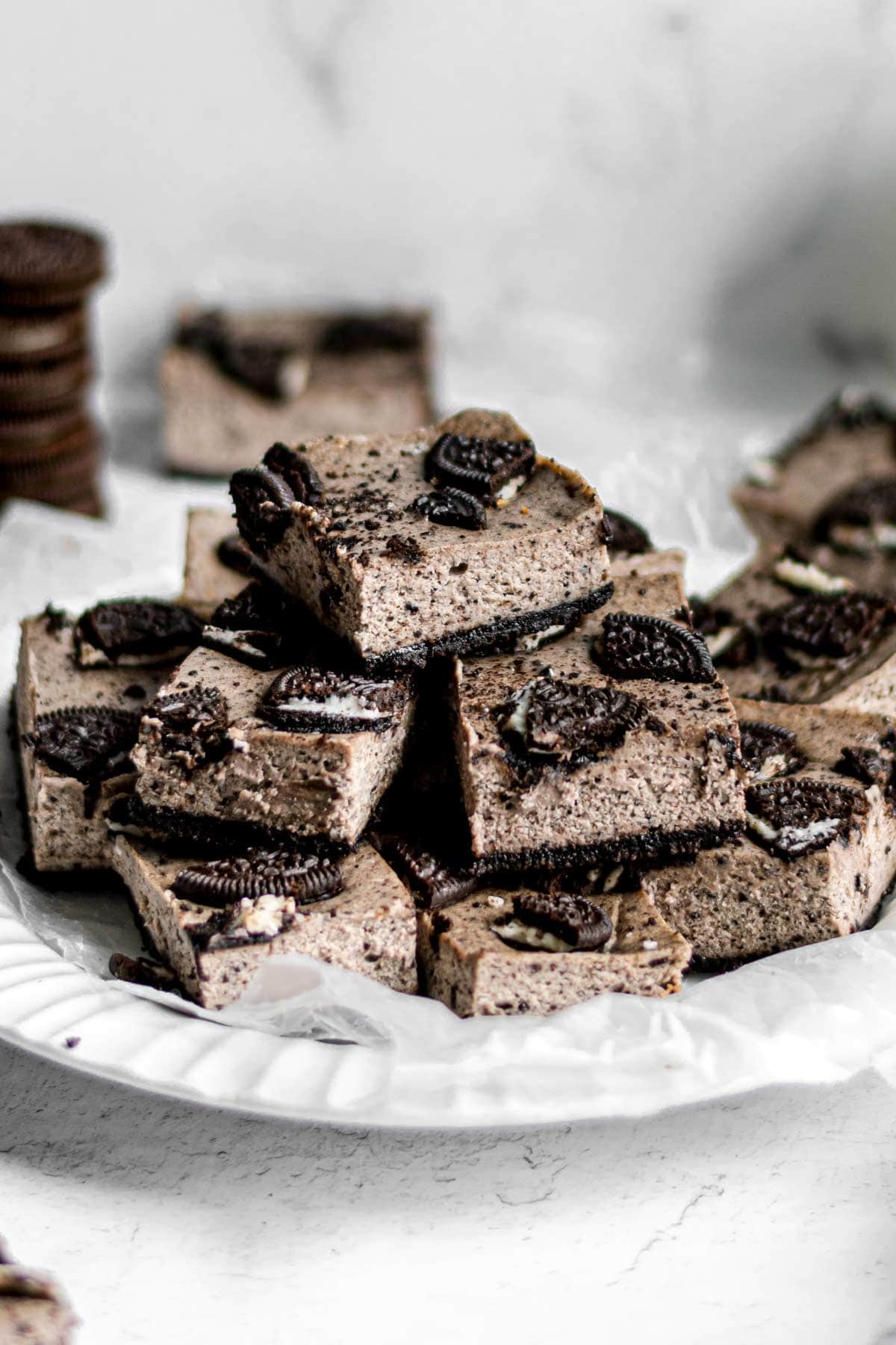 Oreo Cheesecake Bars in pile on plate