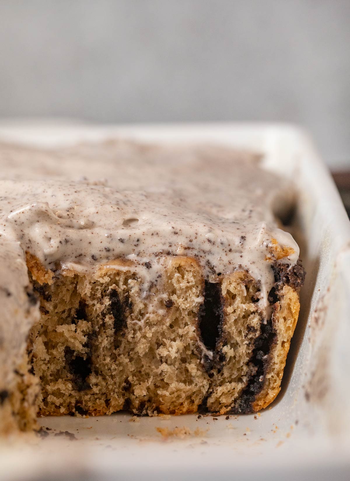 cross-section of Oreo Cinnamon Rolls in baking dish with Oreo frosting