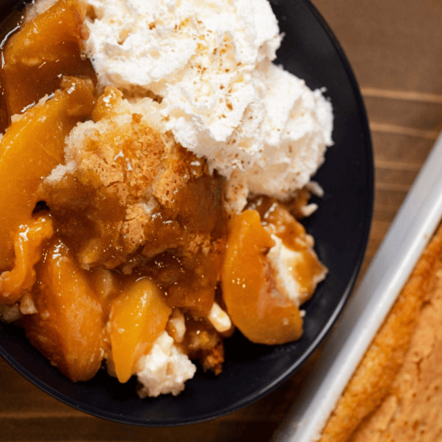 Bowl of cobbler and ice cream sitting on table