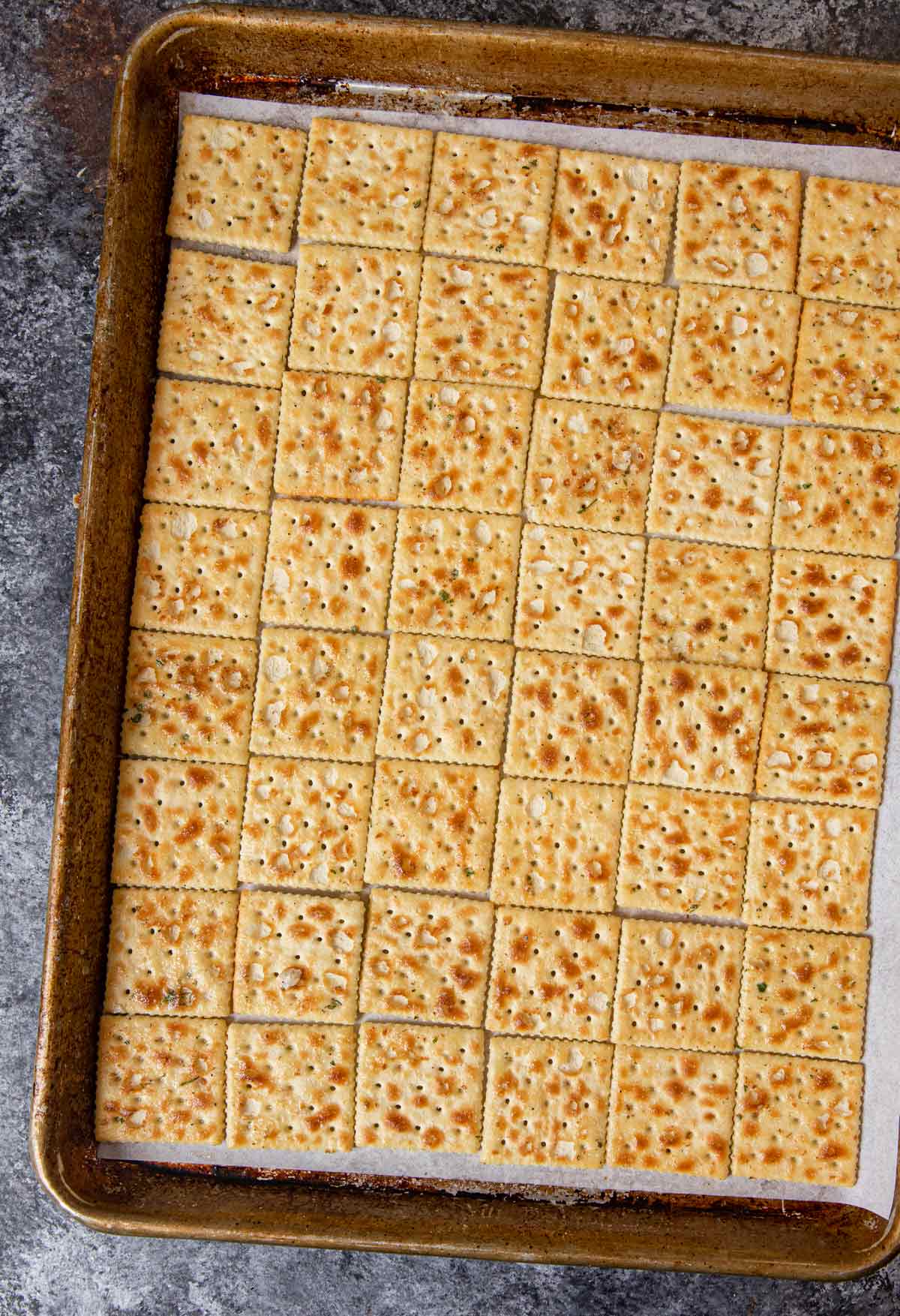 Ranch Mix Saltines lined up on baking sheet