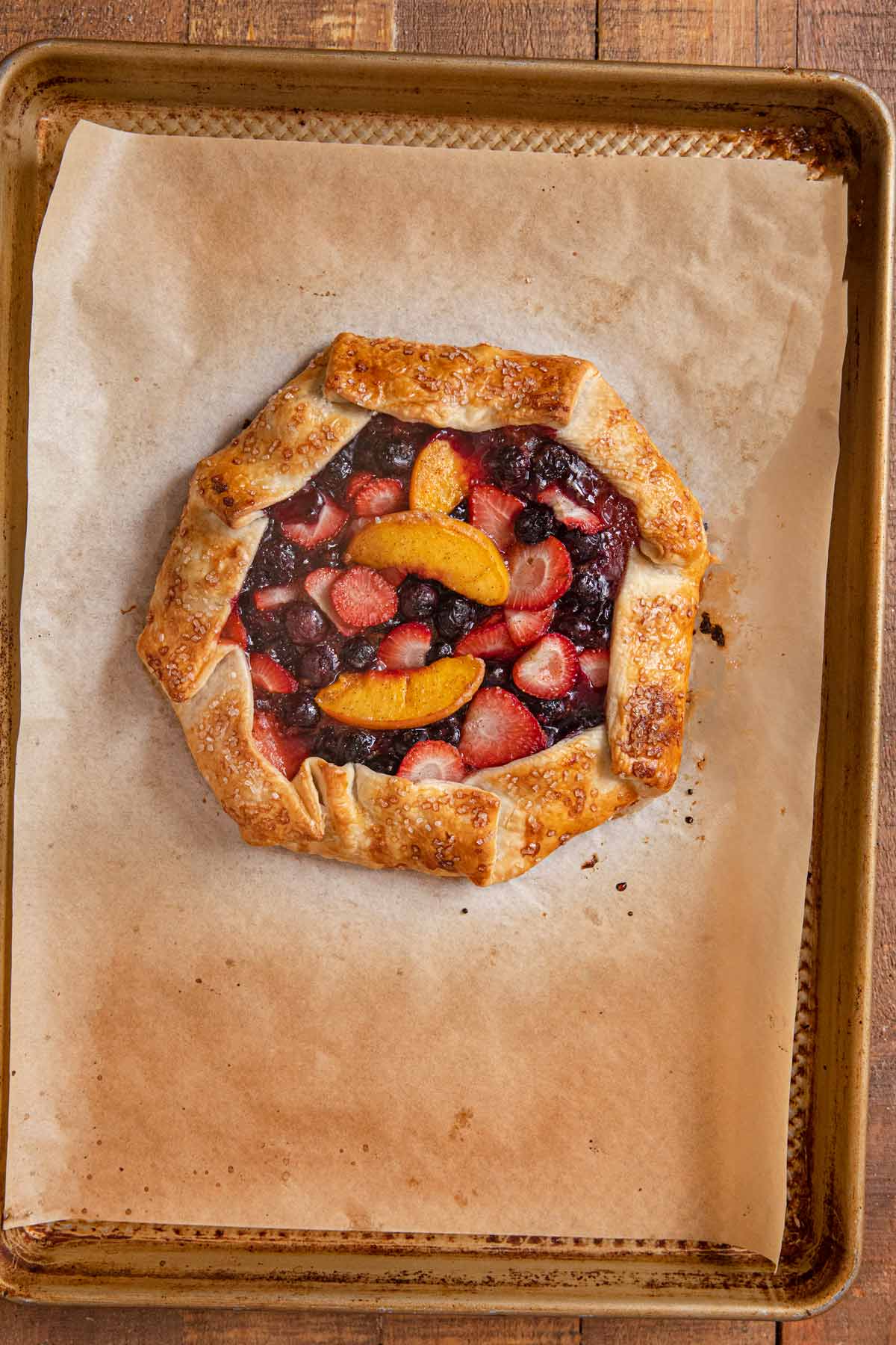 Baked fruit galette on parchment lined baking sheet