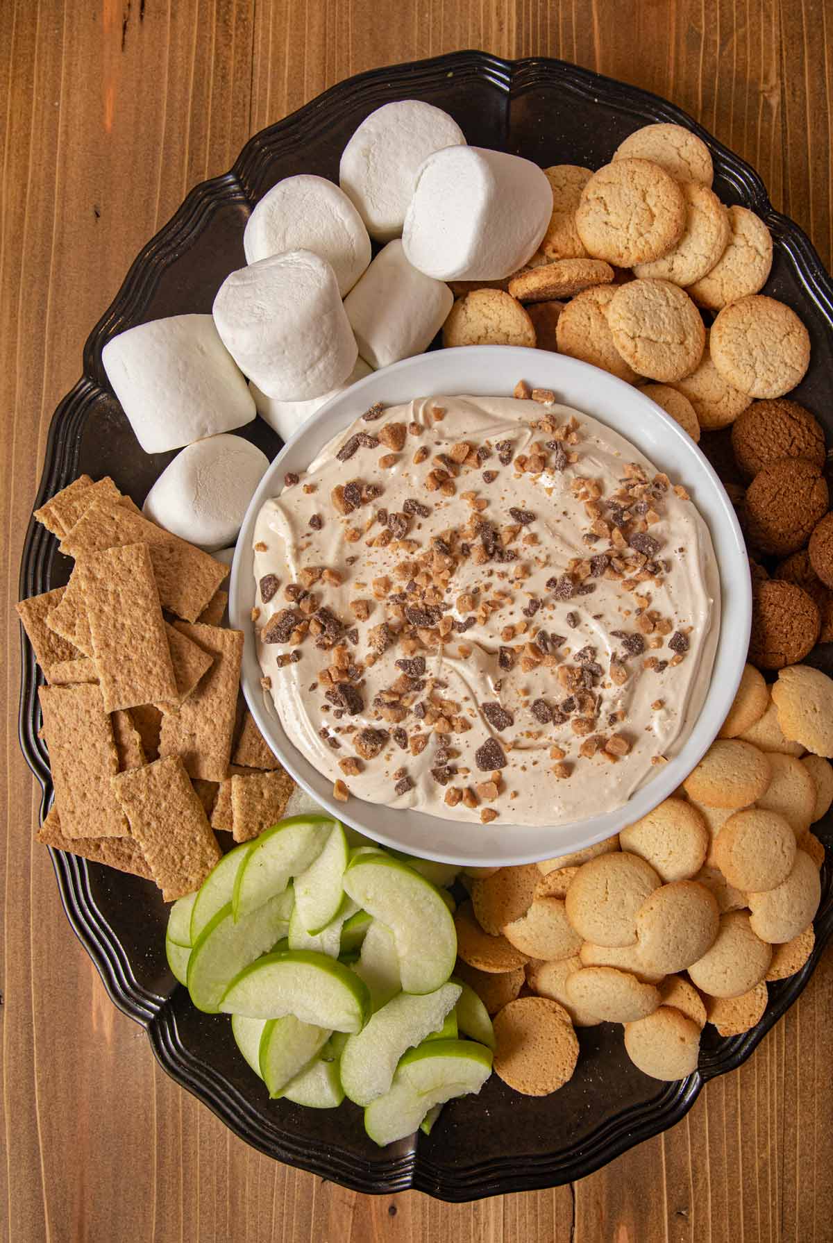 Toffee Apple Dip bowl on tray with foods for dipping