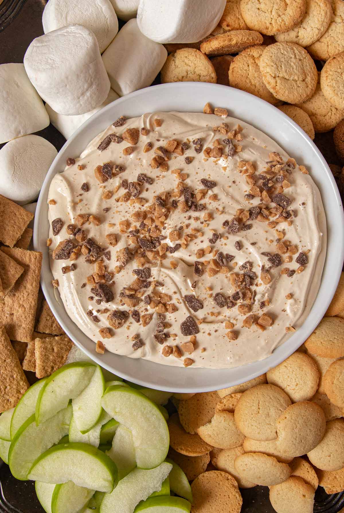 Toffee Apple Dip bowl on tray with foods for dipping