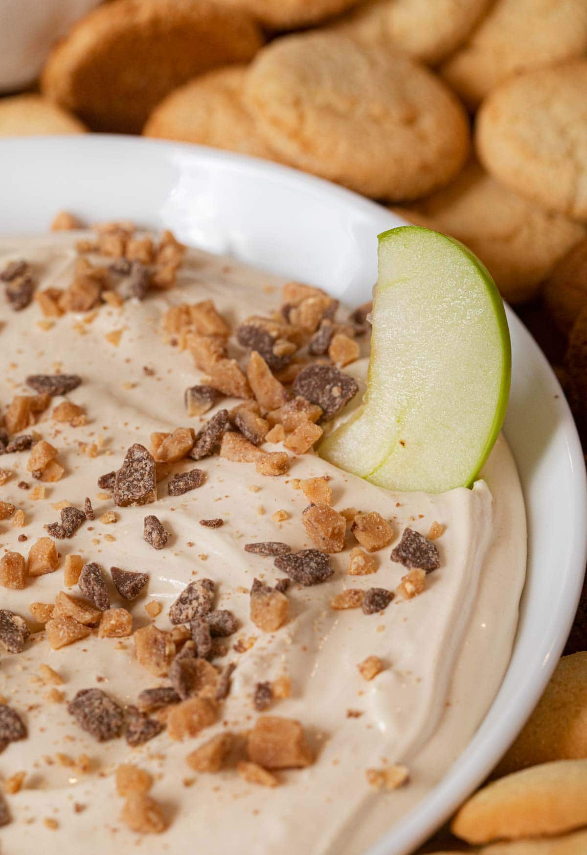 Toffee Apple Dip bowl with green apple slice dipped in