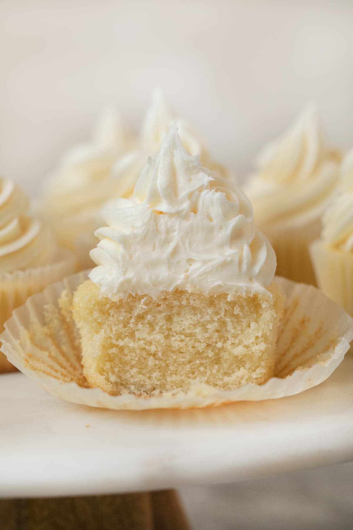 Vanilla Cupcakes with vanilla frosting with bite removed