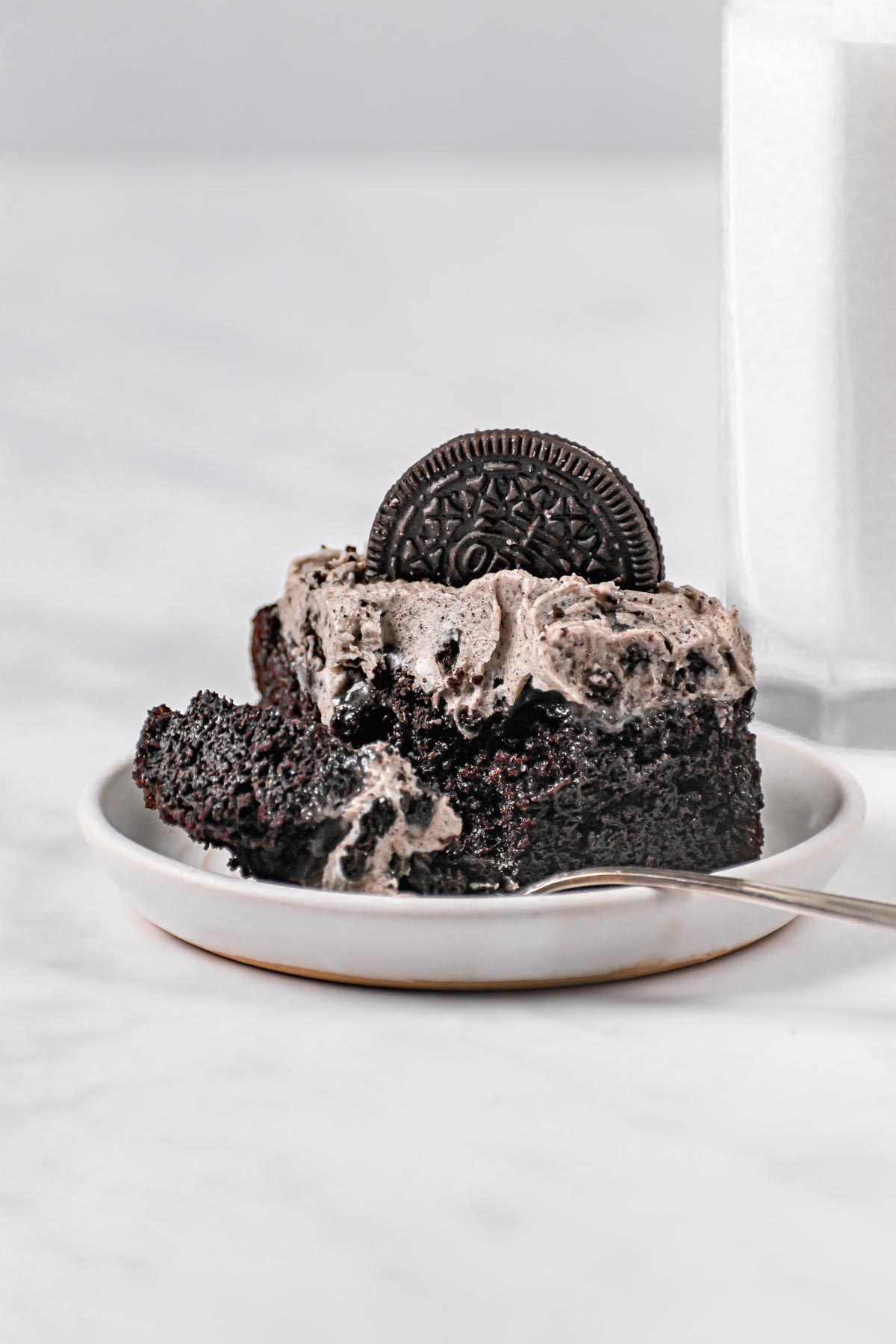 Oreo Poke Cake cut on serving plate