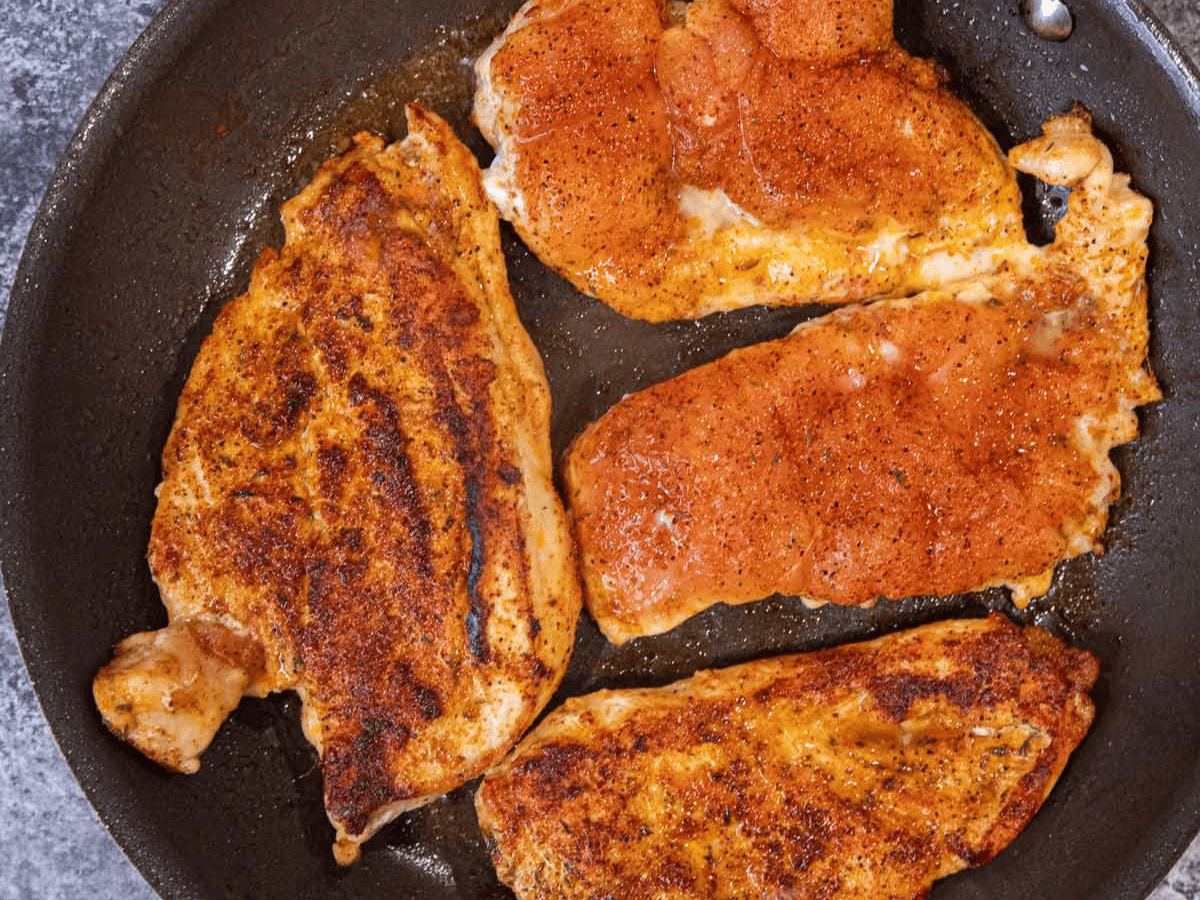chicken searing in a pan