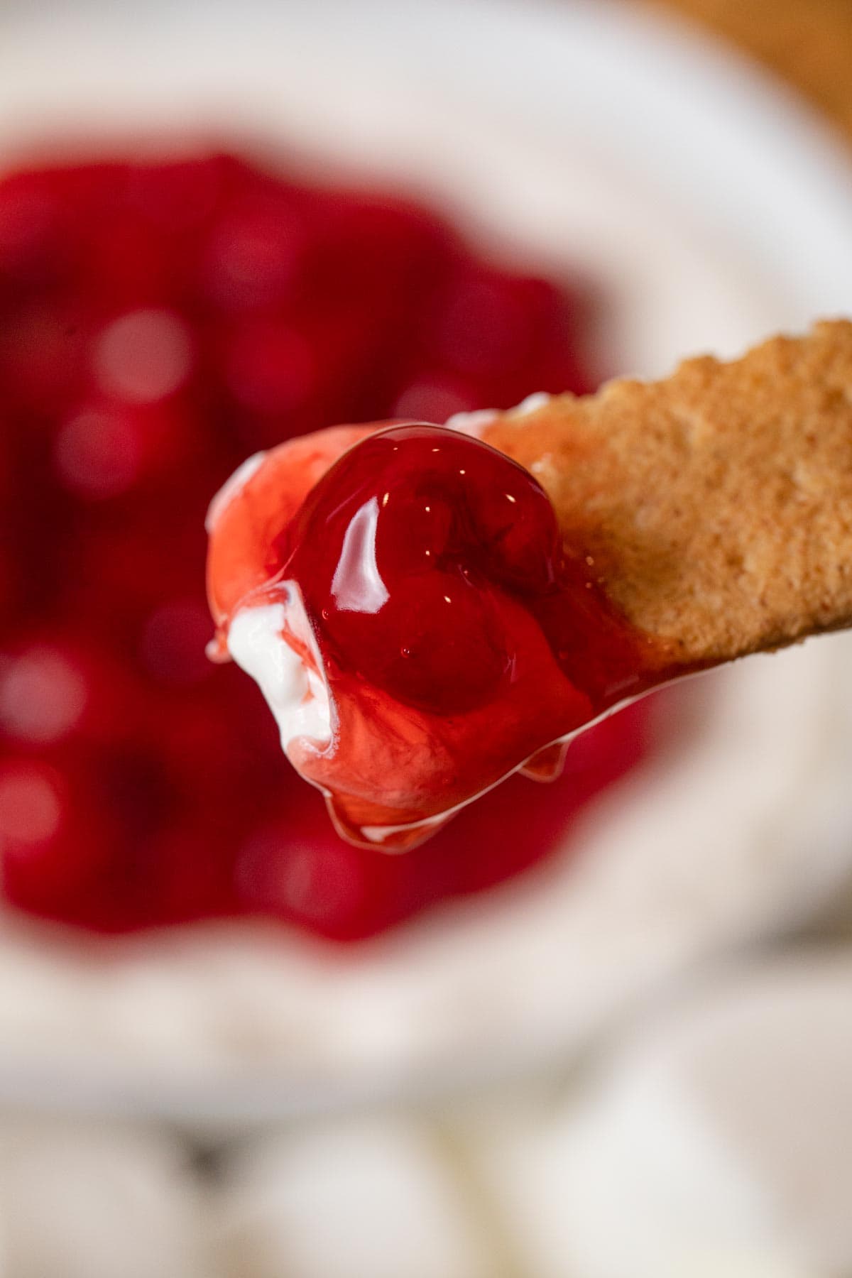 scoop of Cherry Cheesecake Dip on graham cracker dipper