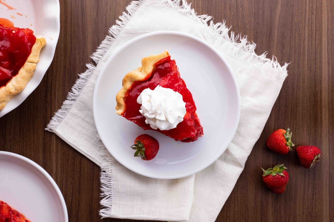 Fresh Strawberry Pie slice on plate with whipped cream