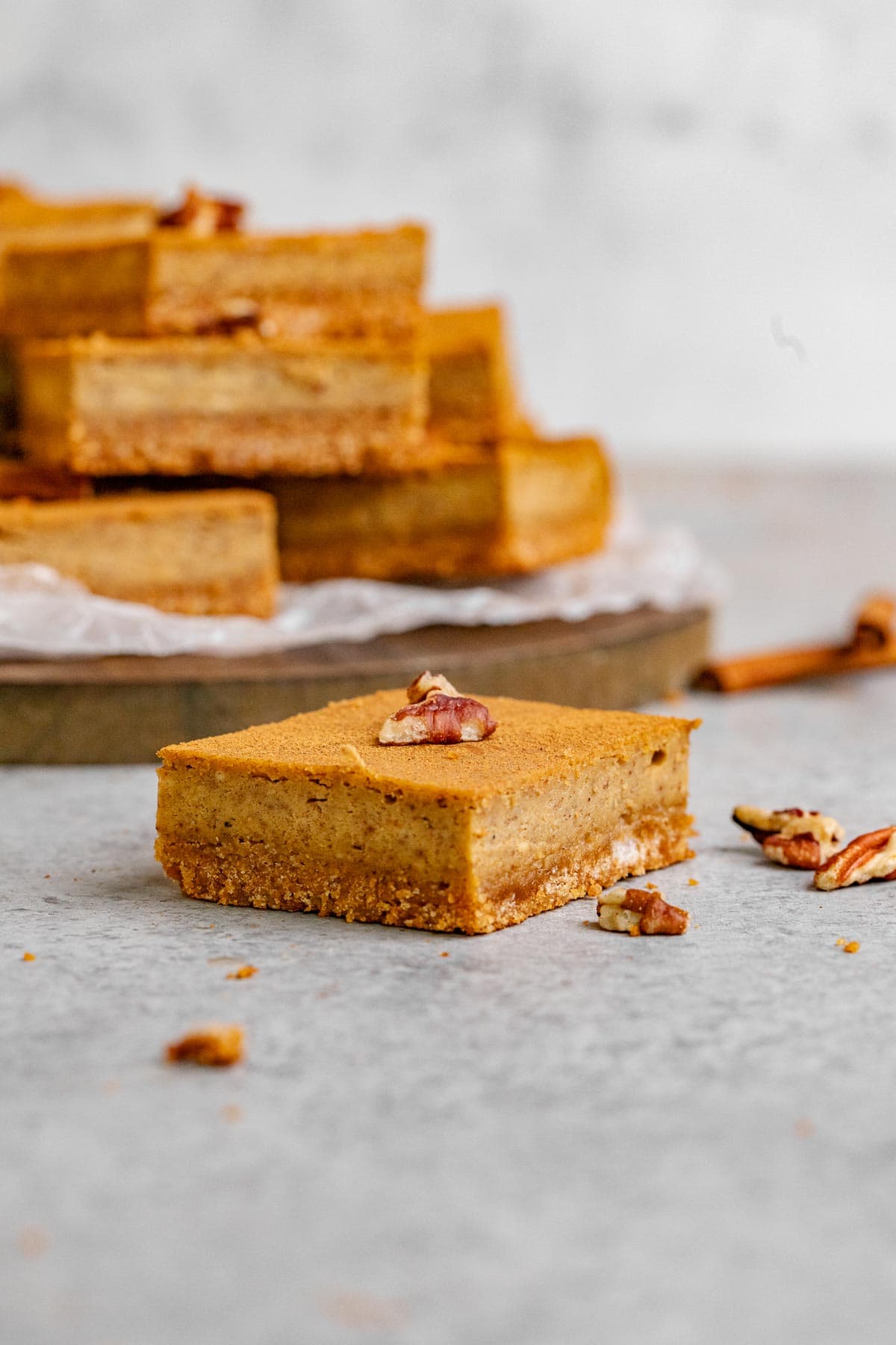 Gingerbread Cheesecake Bars sliced on a board with parchment