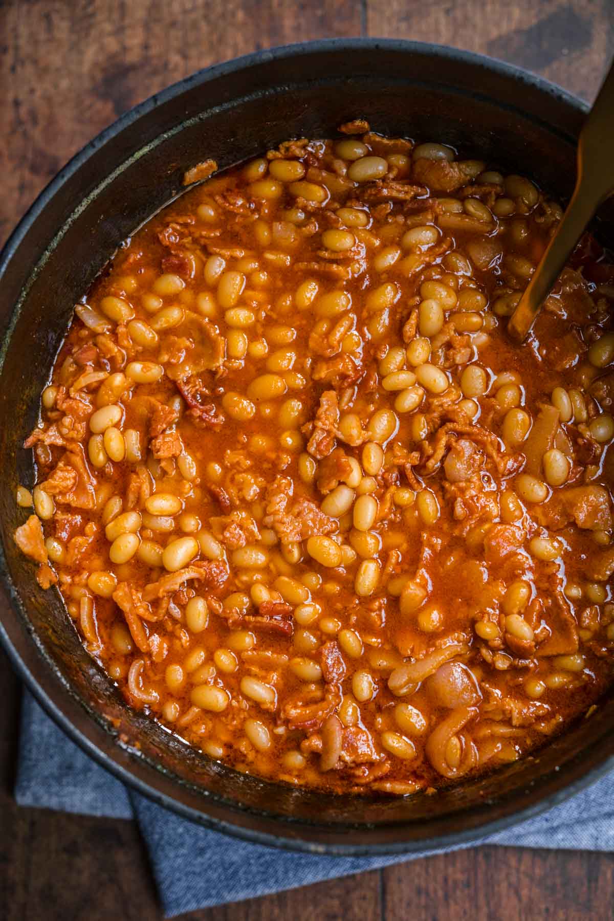 Homemade Pork and Beans with bacon and sauce in pot