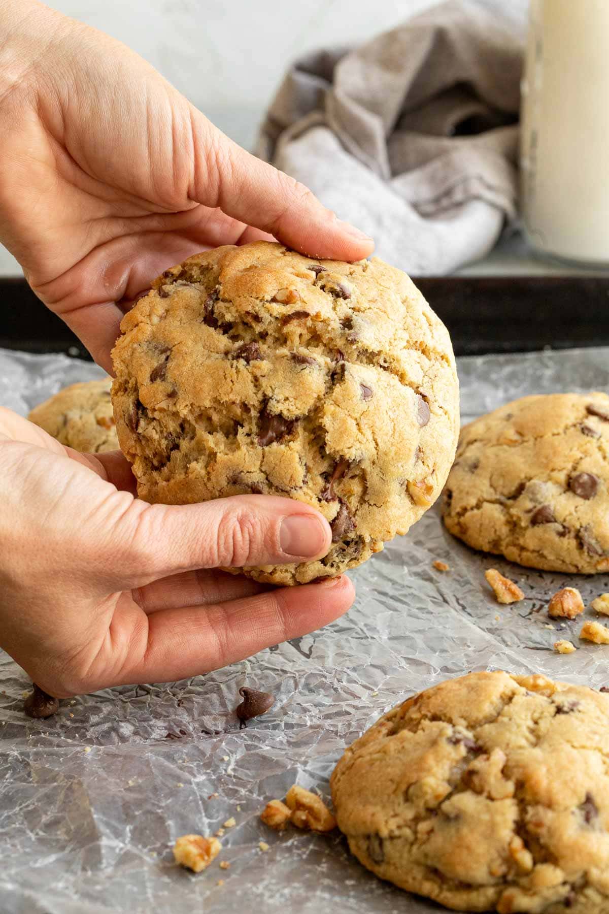 Levain Chocolate Chip Cookies being held by hands