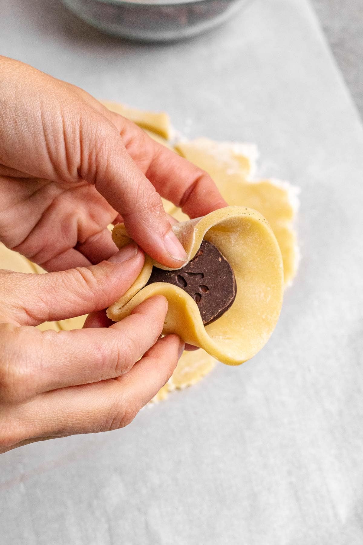Peppermint Filled Cookies forming dough around peppermint patty in hand