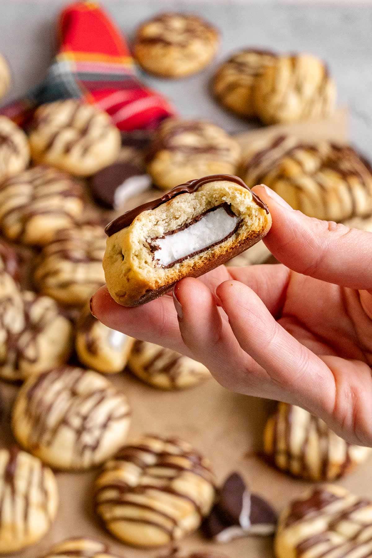 Peppermint Filled Cookies prepared with one cookie in hand with bite taken out