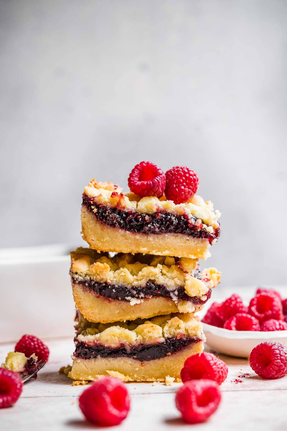 Raspberry Shortbread Bars stack on serving plate