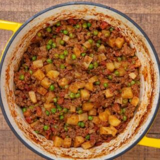 Ground Beef and potatoes in a Dutch Oven.